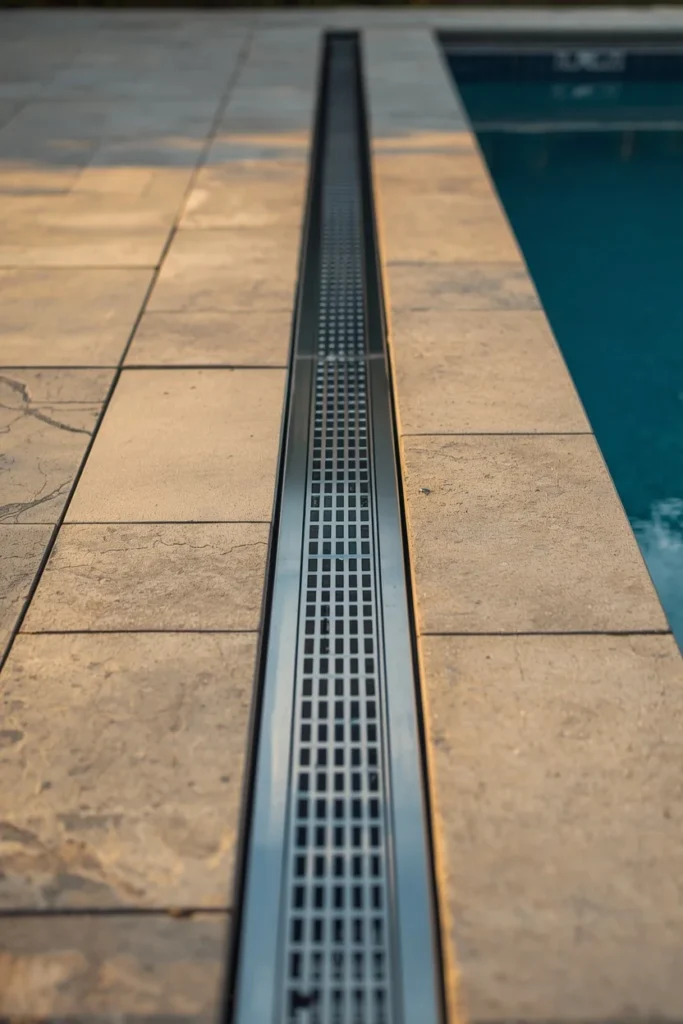  backyard pool deck detail, featuring a sleek stainless steel linear drain