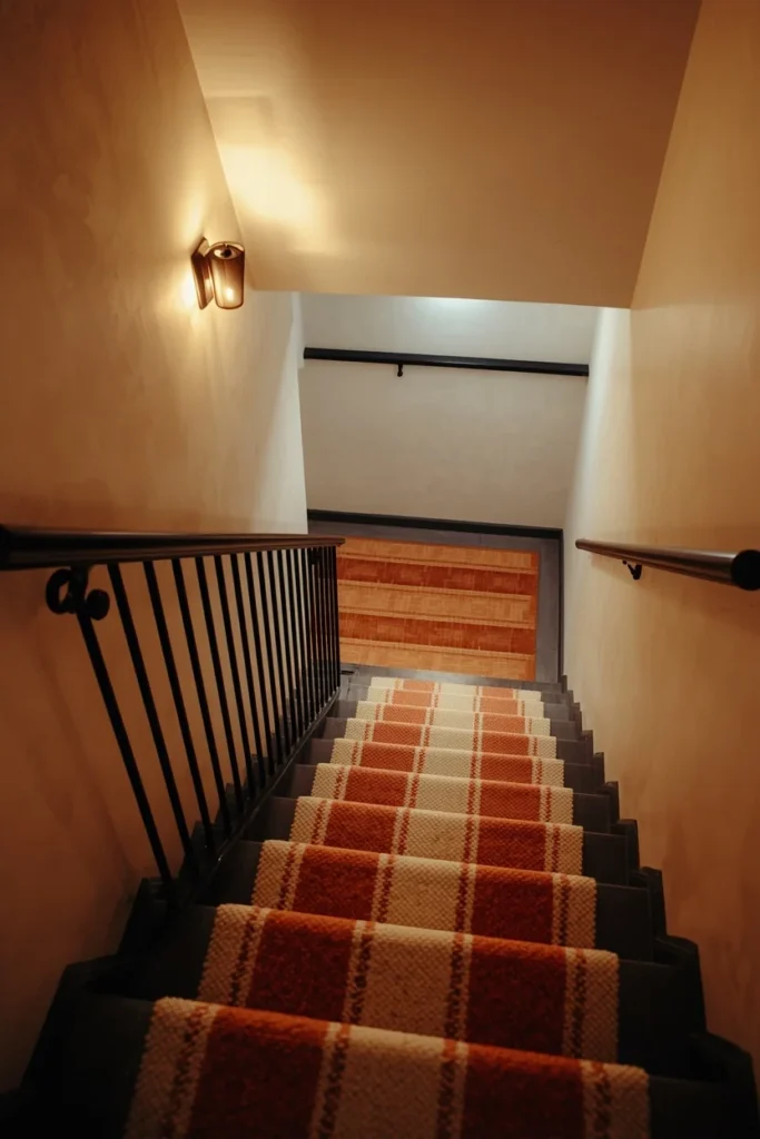 basement staircase, featuring a striped wool stair runner in cream