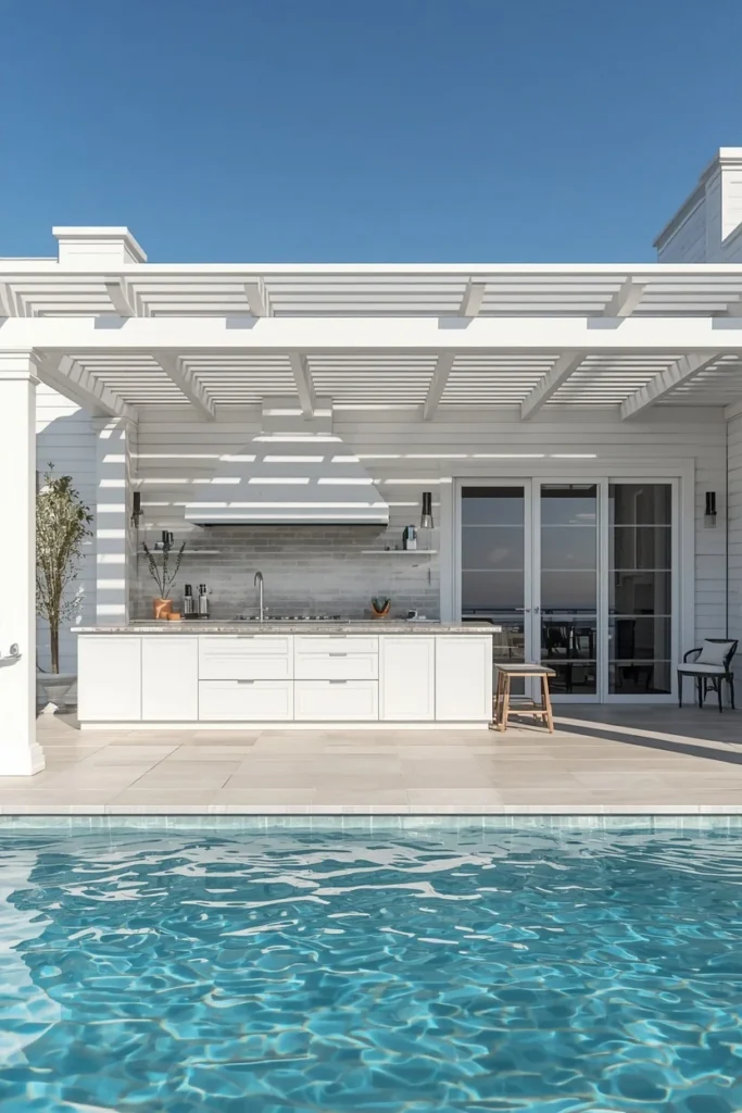 21 Pool House Ideas That Make Your Backyard Feel Like a Luxury Resort 5 coastal pool house, featuring white shaker outdoor kitchen