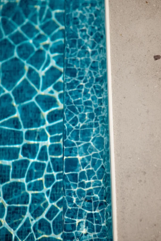 backyard pool detail, featuring a bold geometric mosaic waterline tile pattern 