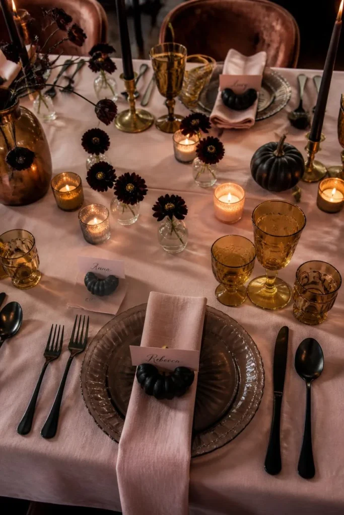  dining table set for Halloween dinner, featuring a blush pink tablecloth