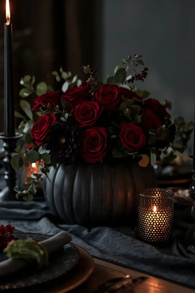 15 Pumpkin Floral Arrangement Ideas for Fall Tables That Feel Effortlessly Elegant 5 dining table, featuring a dark charcoal pumpkin filled with deep red roses and near-black dahlias,