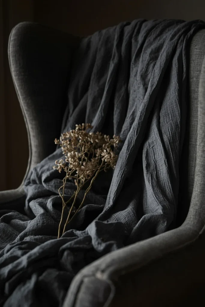 wingback armchair, featuring loosely draped charcoal gray cheesecloth fabric 