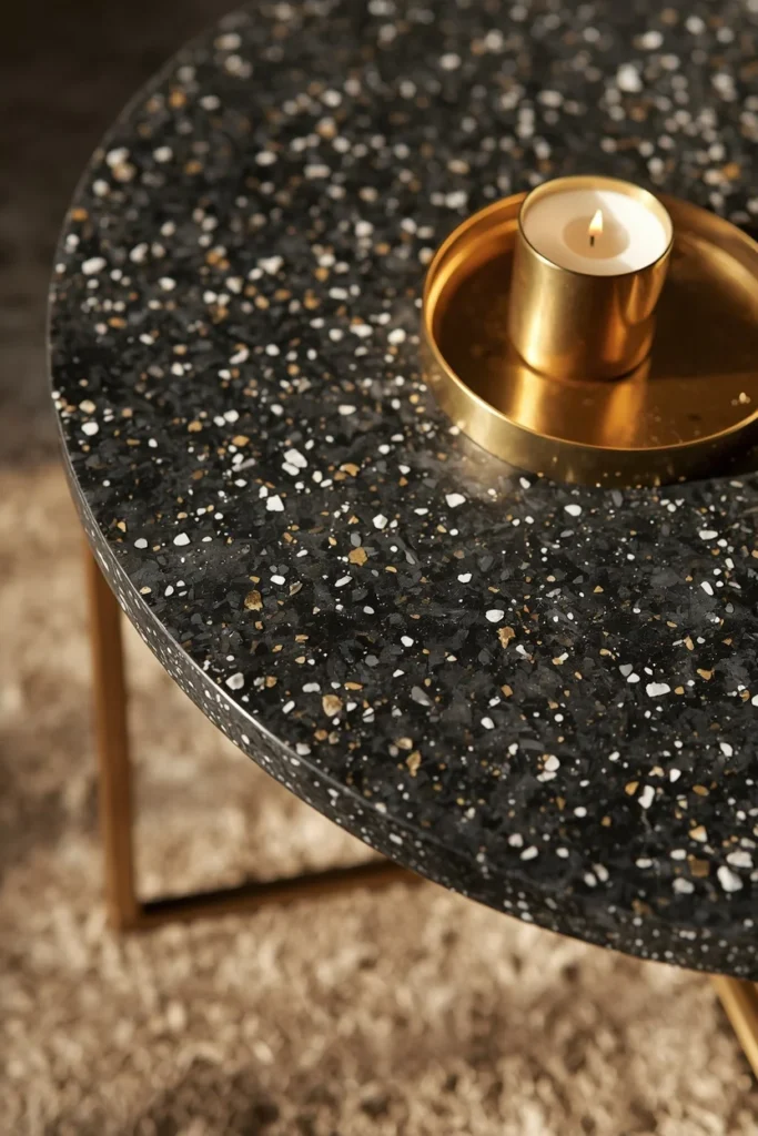 22 Cosmic Interior Design Ideas for a Starry, Galaxy-Inspired Home 11 furniture detail shot, featuring a dark terrazzo coffee table with white and gold stone flecks