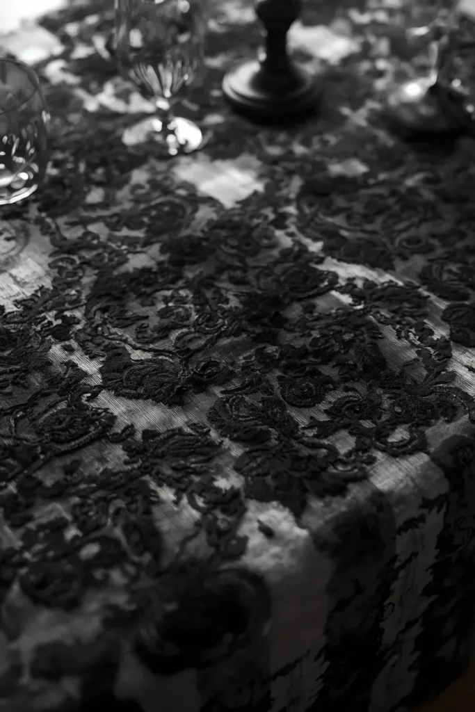 15 Last-Minute Halloween Tablescape Ideas That Look Planned 15 dining table linen close-up, featuring black lace fabric layered