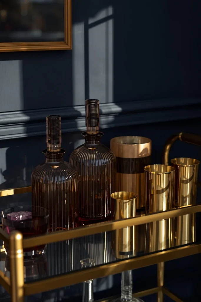 22 Cosmic Interior Design Ideas for a Starry, Galaxy-Inspired Home 23 bar cart styling shot, featuring a brass bar cart with smoky glass decanters, brass barware