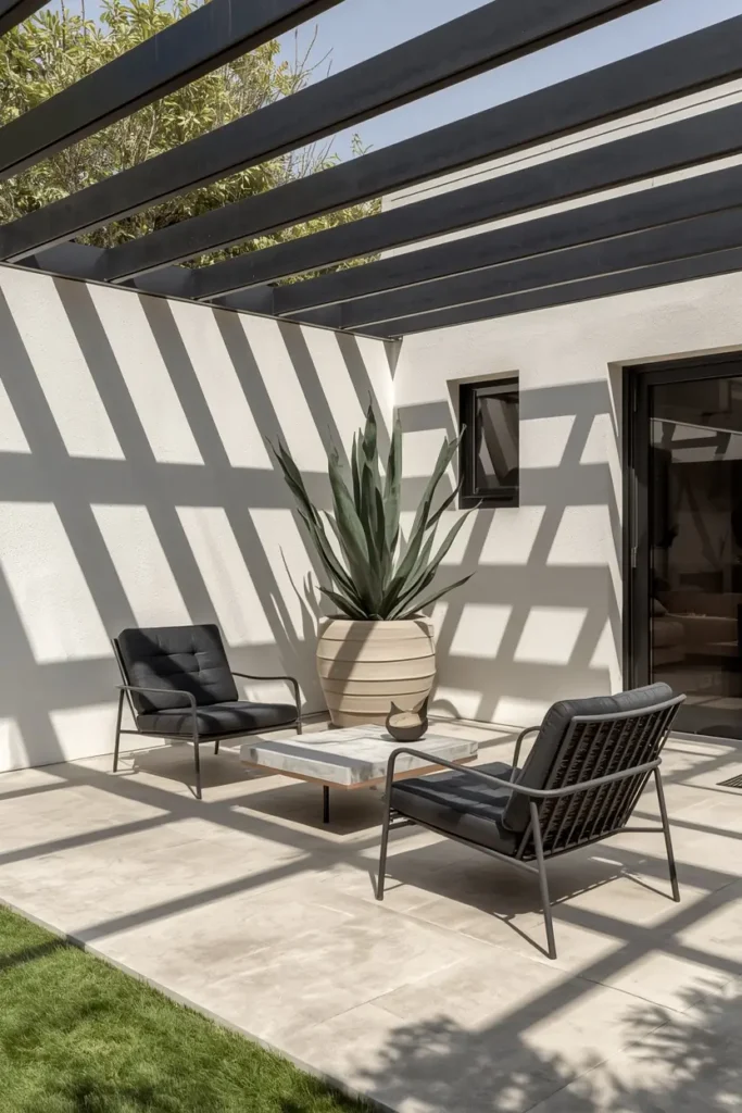 backyard patio, featuring a matte black steel pergola with thin clear-span beams