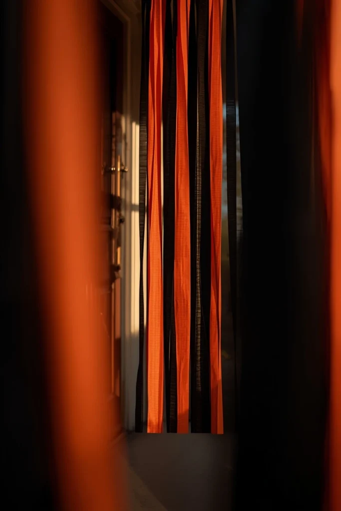 front door entrance, featuring hanging black and orange crepe paper streamer fringe 