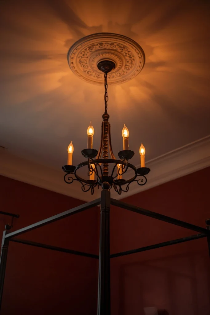 21 Vampy Romantic Bedroom Ideas for a Moody, Gothic-Chic Retreat 8 bedroom ceiling shot, featuring a dark wrought iron chandelier with warm candle-style